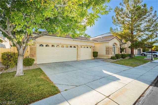 ranch-style home with a garage and a front yard