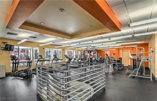 exercise room featuring a tray ceiling