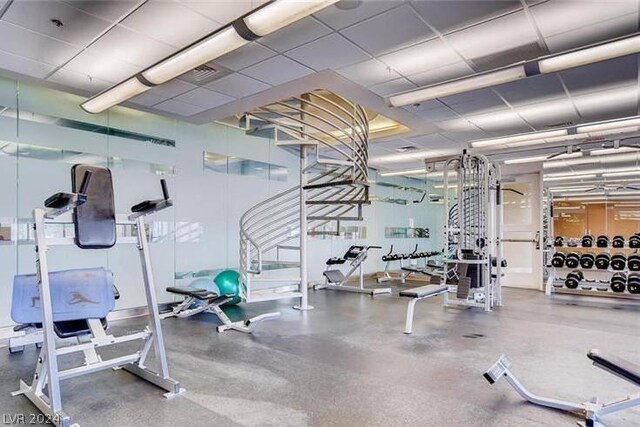 gym featuring a paneled ceiling