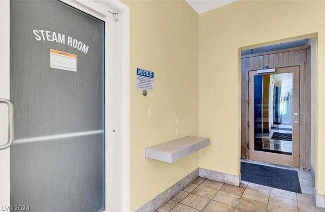 hall featuring light tile patterned floors