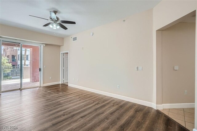 empty room with hardwood / wood-style floors and ceiling fan