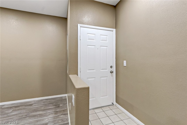 entryway featuring light tile patterned flooring and baseboards