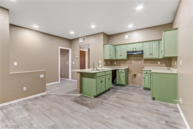 kitchen with sink, dishwasher, light hardwood / wood-style floors, green cabinetry, and kitchen peninsula