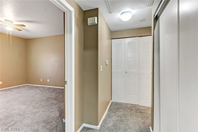 hallway featuring light carpet