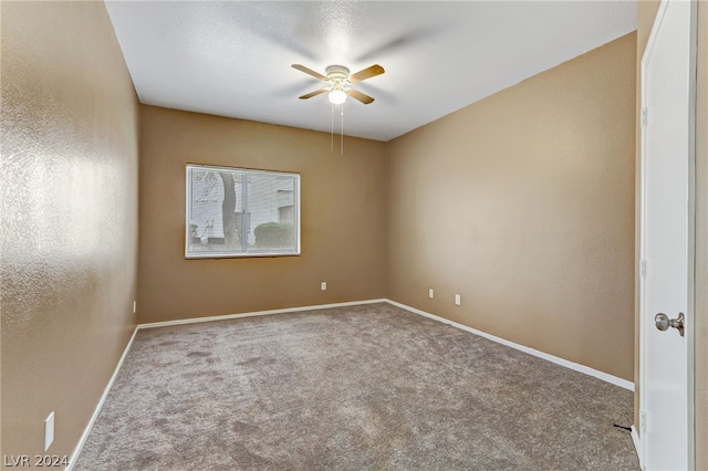 empty room featuring carpet floors and ceiling fan