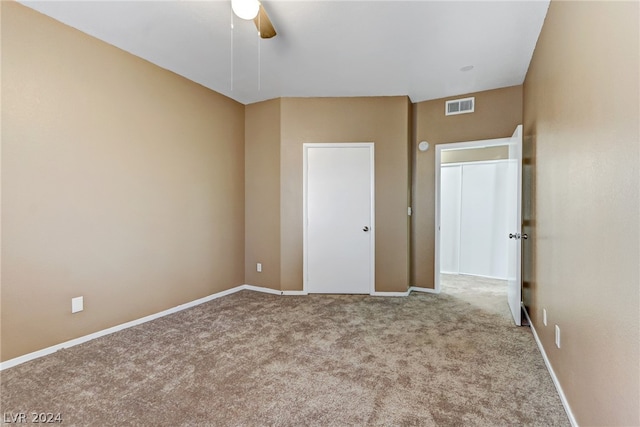 unfurnished bedroom with light carpet and ceiling fan