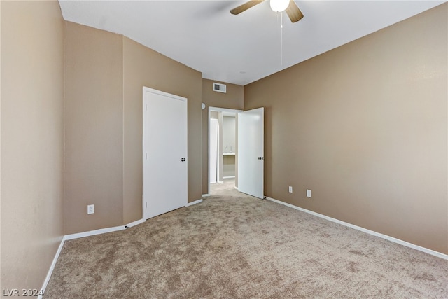 unfurnished bedroom featuring carpet, baseboards, ceiling fan, and visible vents