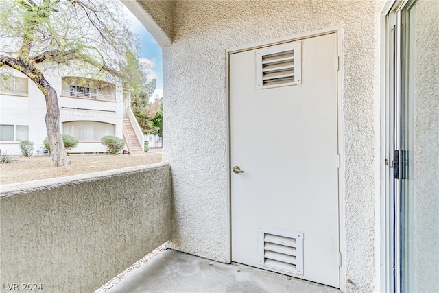 exterior space featuring stucco siding and a balcony