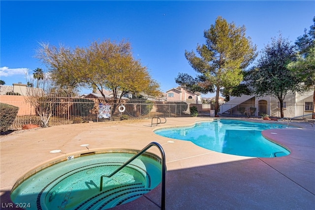 view of swimming pool with a community hot tub and a patio