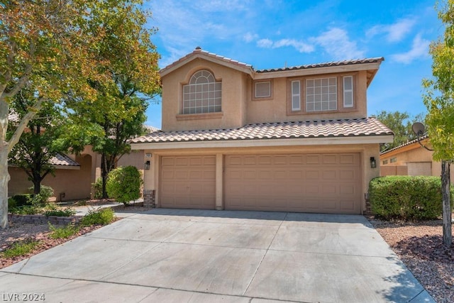 mediterranean / spanish-style home featuring a garage