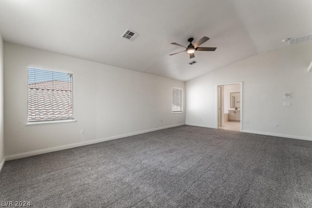 carpeted spare room featuring ceiling fan and lofted ceiling