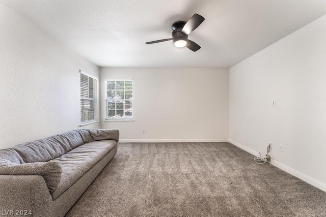 carpeted living room with ceiling fan