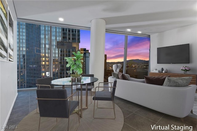 living room with dark tile patterned floors and expansive windows