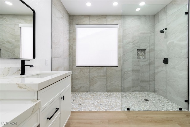 bathroom with an enclosed shower, vanity, and hardwood / wood-style flooring