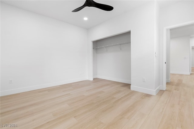 unfurnished bedroom featuring ceiling fan, light hardwood / wood-style flooring, and a closet