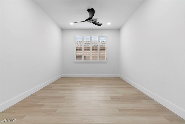 empty room with ceiling fan and light hardwood / wood-style flooring