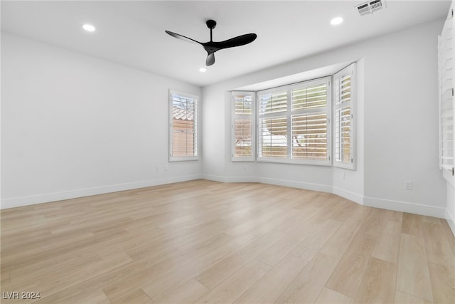 spare room featuring ceiling fan and light hardwood / wood-style flooring