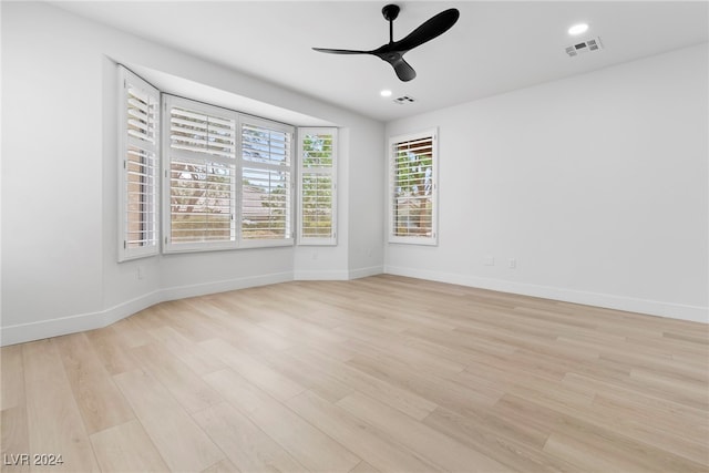 empty room with light wood-type flooring and ceiling fan