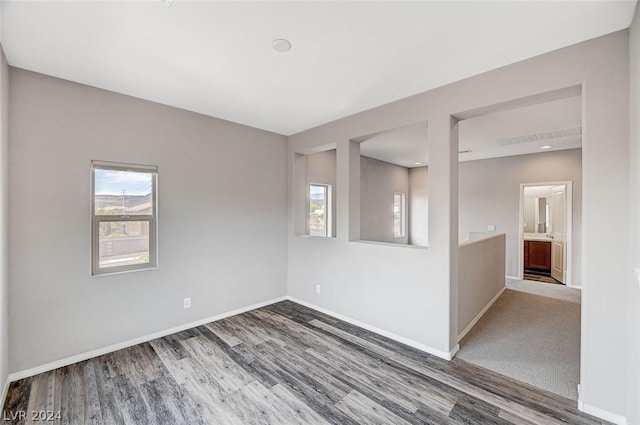 unfurnished room with wood-type flooring