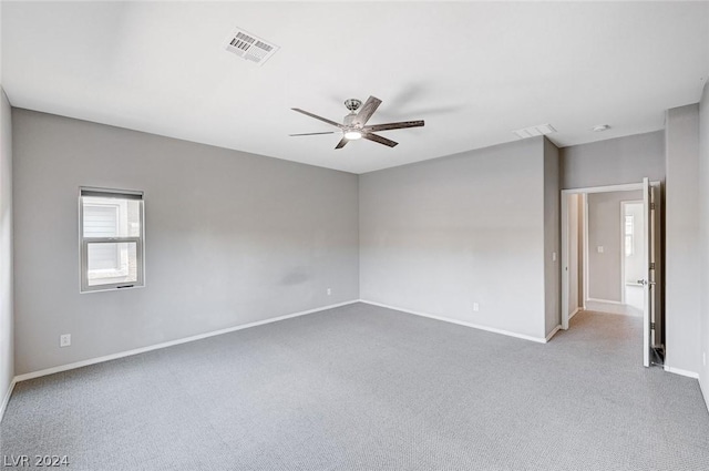 empty room with light carpet and ceiling fan