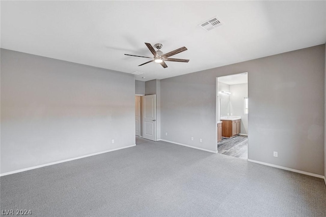 empty room featuring light colored carpet and ceiling fan