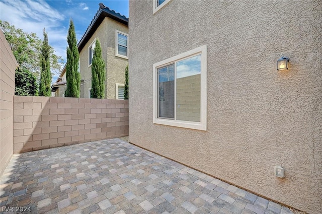 view of side of property featuring a patio area