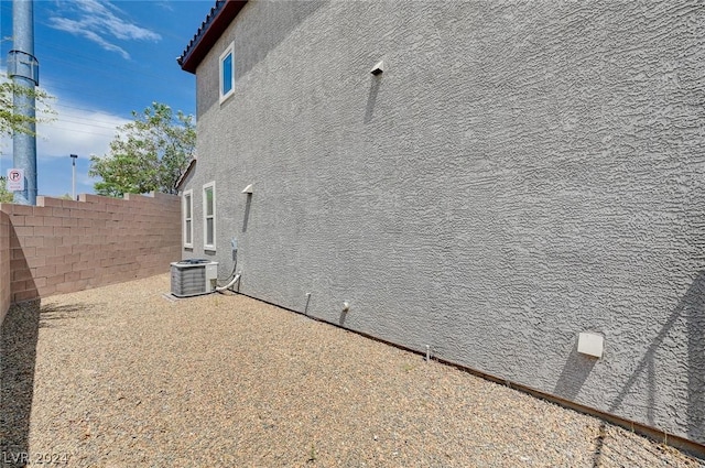 view of property exterior with central AC and a patio area