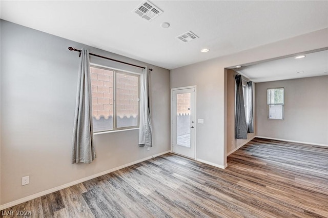 spare room featuring wood-type flooring