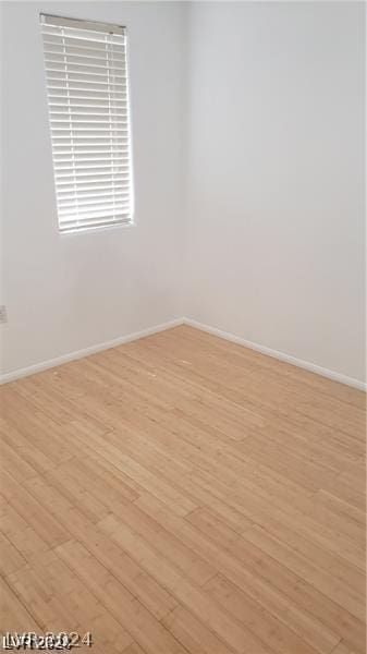 unfurnished room with light wood-type flooring