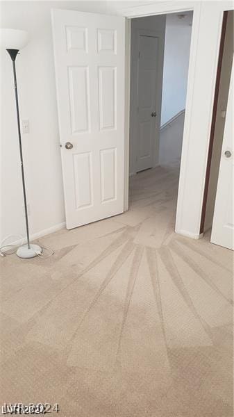 unfurnished bedroom featuring light colored carpet