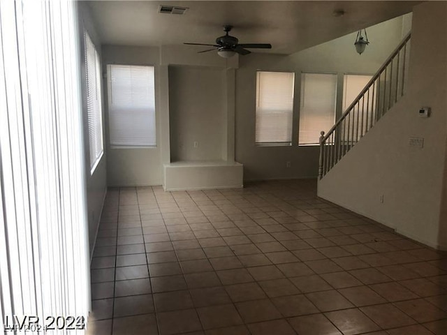 unfurnished room with ceiling fan and tile patterned floors