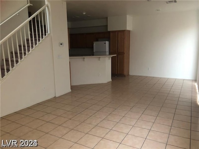 unfurnished living room with light tile patterned flooring