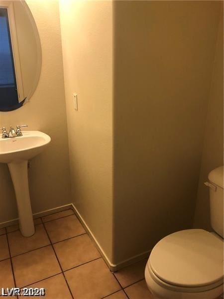 bathroom with sink, tile patterned floors, and toilet