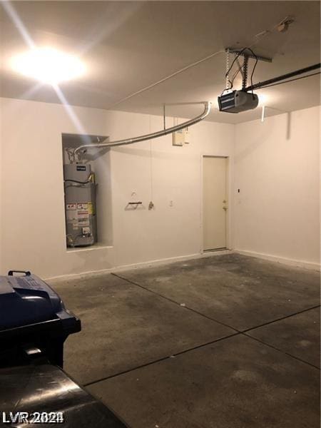 garage featuring gas water heater and a garage door opener