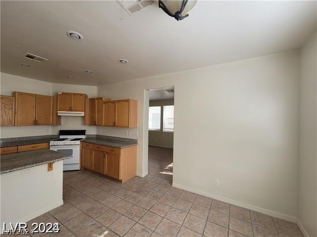 kitchen with light tile patterned floors and white range with gas cooktop