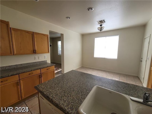 kitchen featuring light tile patterned flooring and sink