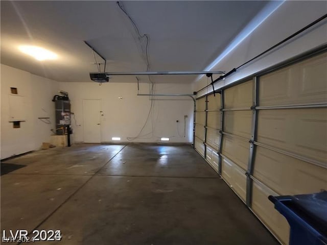 garage with water heater and a garage door opener