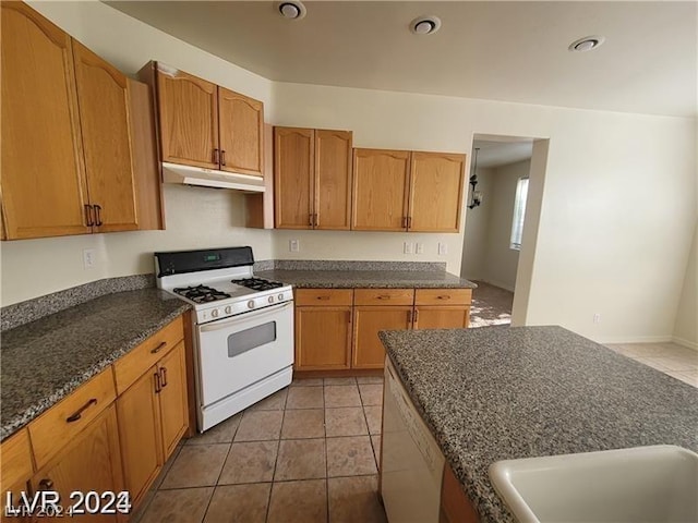 kitchen with light tile patterned floors and white appliances