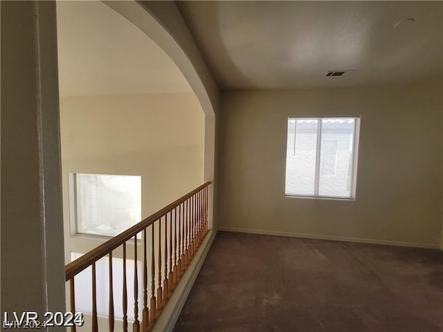 hallway with dark carpet