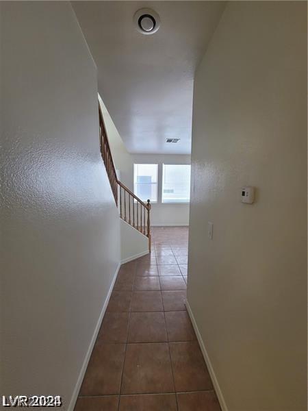 hallway with tile patterned flooring