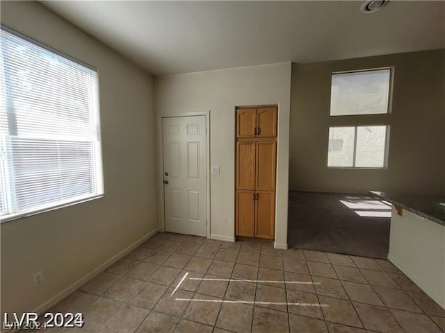 unfurnished room with tile patterned flooring