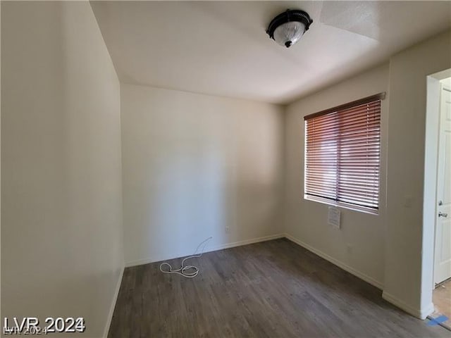 empty room with dark hardwood / wood-style flooring