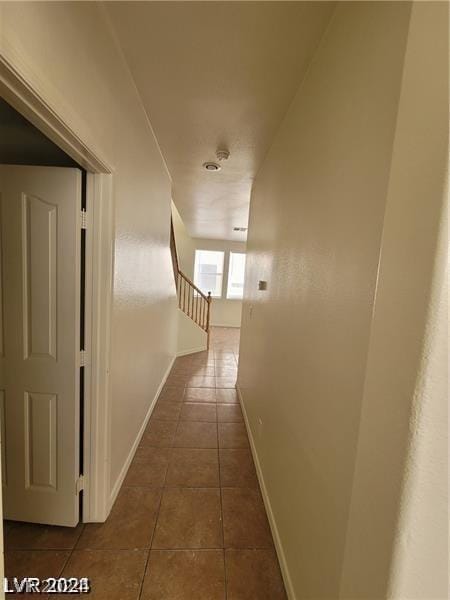 corridor featuring dark tile patterned flooring