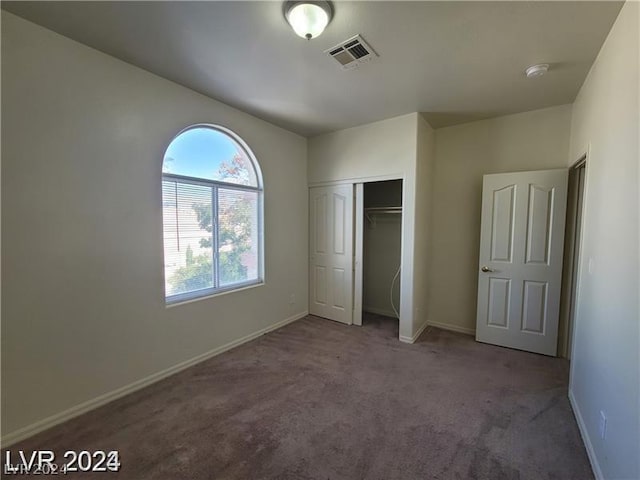 unfurnished bedroom with carpet floors and a closet