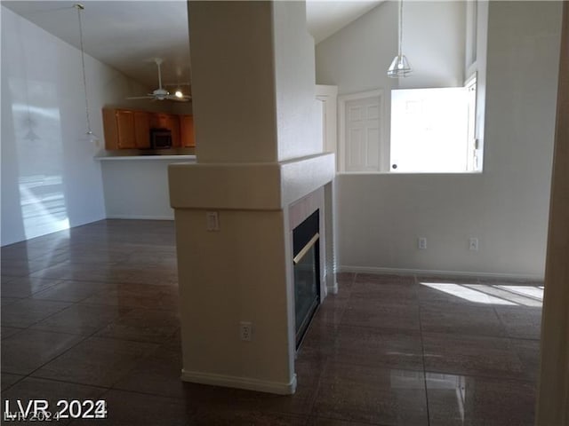 kitchen with high vaulted ceiling, hanging light fixtures, and ceiling fan