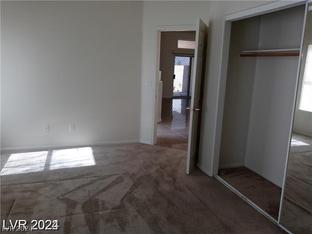 unfurnished bedroom featuring carpet floors and a closet