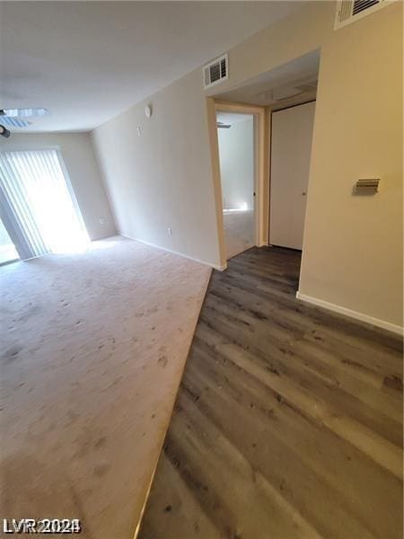 spare room featuring dark wood-type flooring