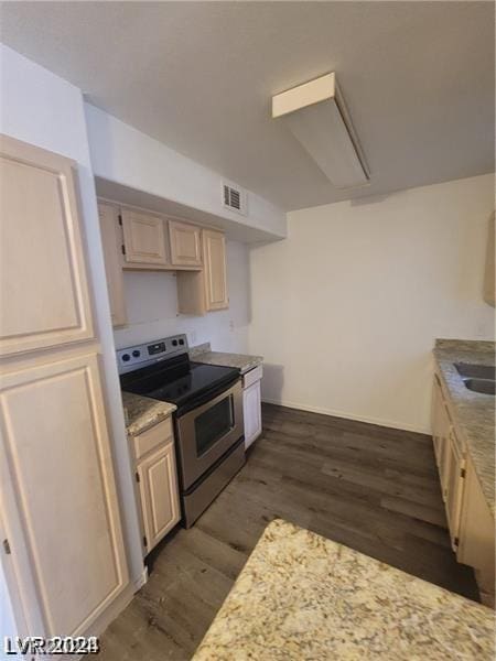 kitchen with stainless steel electric range oven and dark hardwood / wood-style flooring