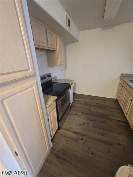 kitchen with cream cabinets, dark hardwood / wood-style floors, and stainless steel electric range oven