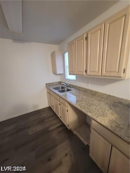 kitchen featuring light stone countertops, sink, and dark hardwood / wood-style floors